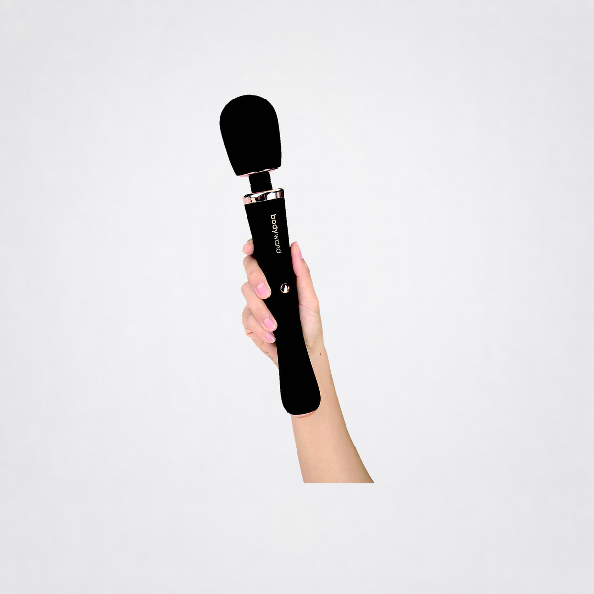 Lux Couture Wand shown in hand on the Luv Coach grey studio background