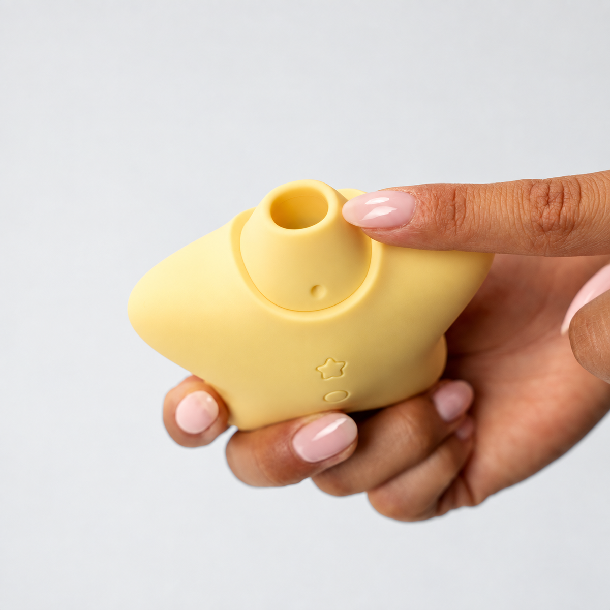 Star Power Airotic Vibrator shown in hand in a square grey-framed photo