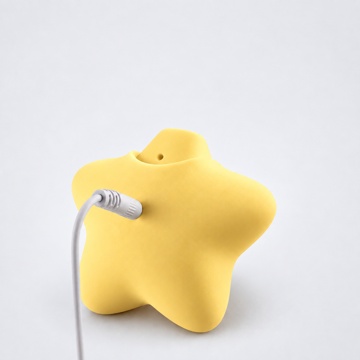 Star Power Airotic Vibrator charging view on the Luv Coach grey studio background