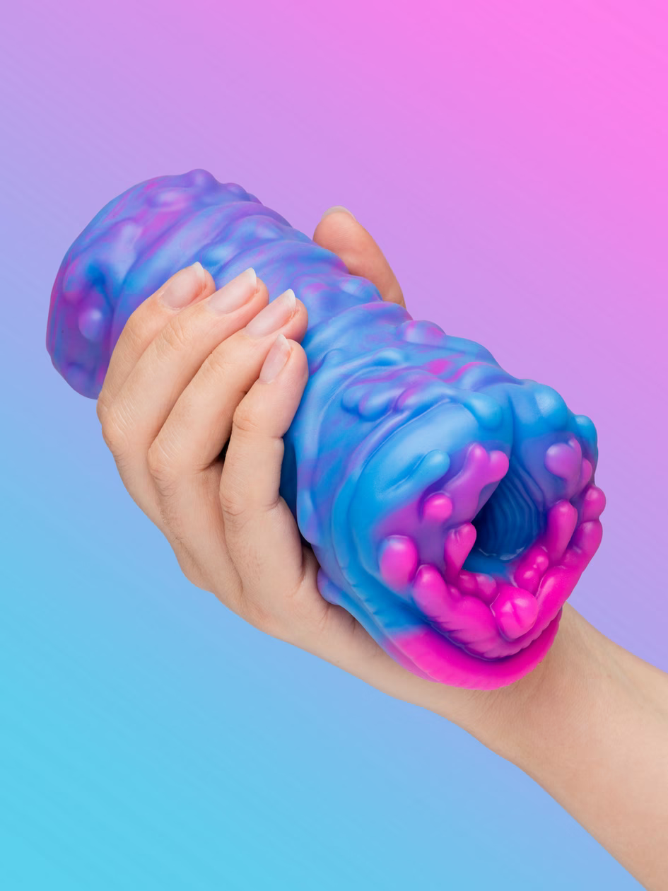 The Creature Str*ker in blue and purple, held in one hand