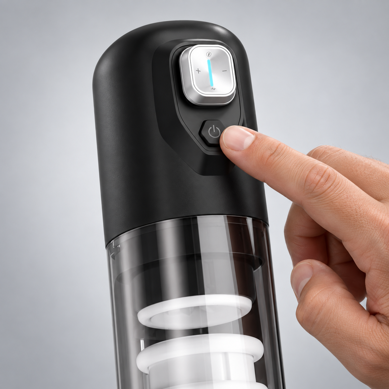 Finger holding Spark's power button to turn the device on