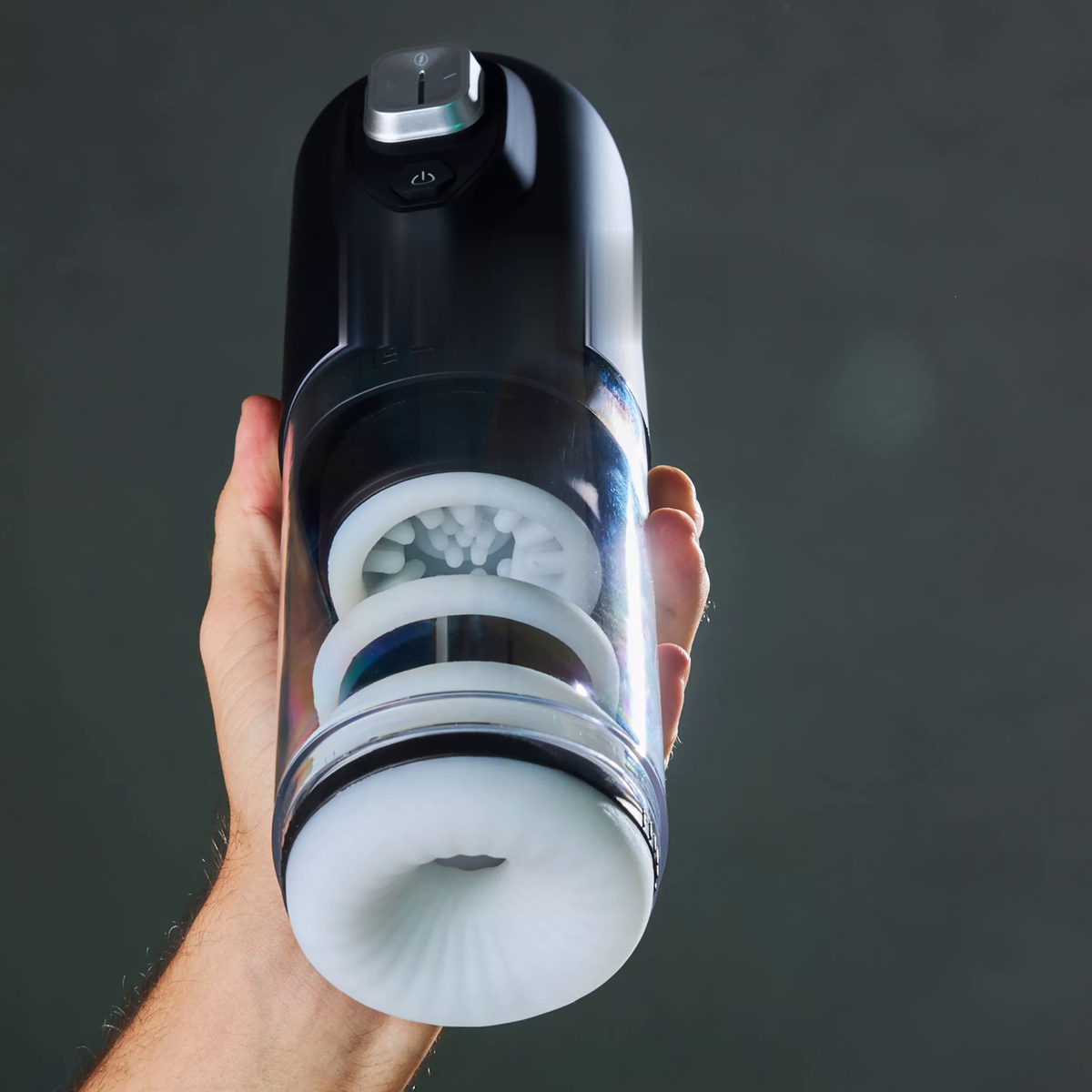SVibe Spark held in one hand with the textured sleeve and rotating inner surface visible