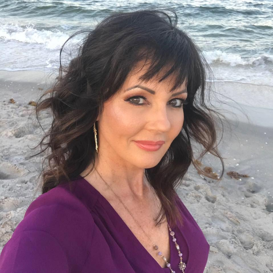 Dana, The Luv Coach, smiling at the beach