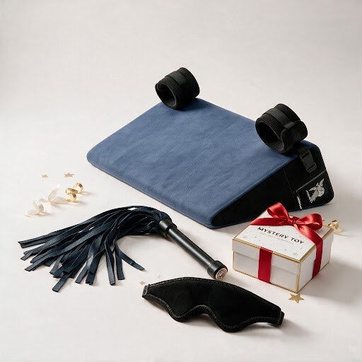 Ho Ho Oh Kinkmas Box with royal blue wedge, wrist cuffs, blindfold, intro flogger and mystery toy