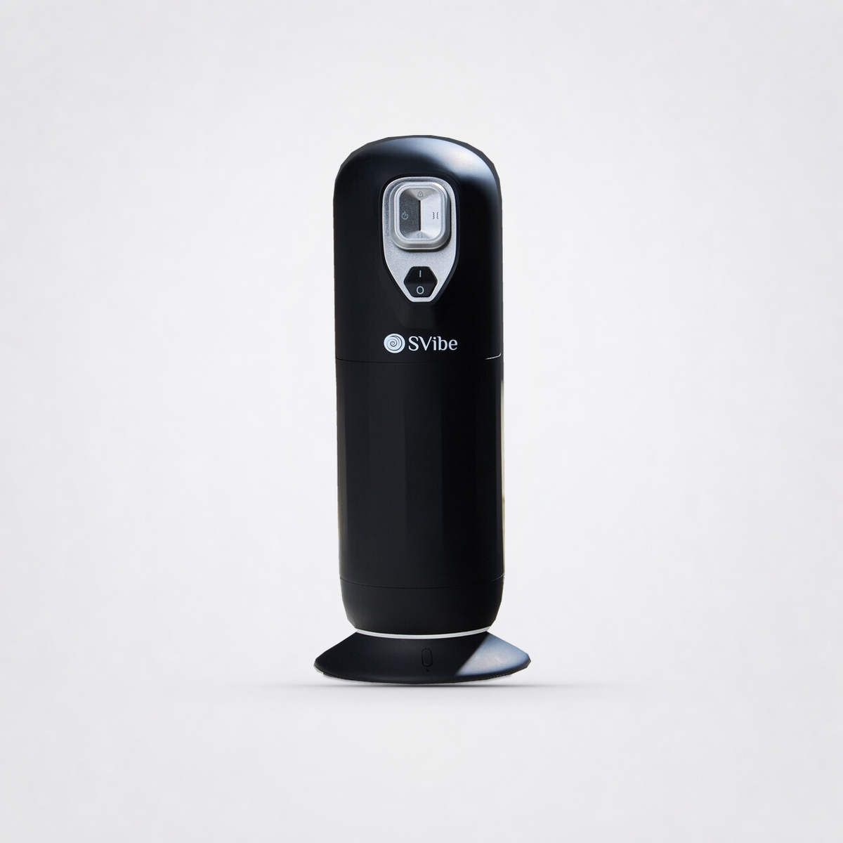 Front view of the black SVIBE JET massager on its MagHeat base on The Luv Coach grey studio background