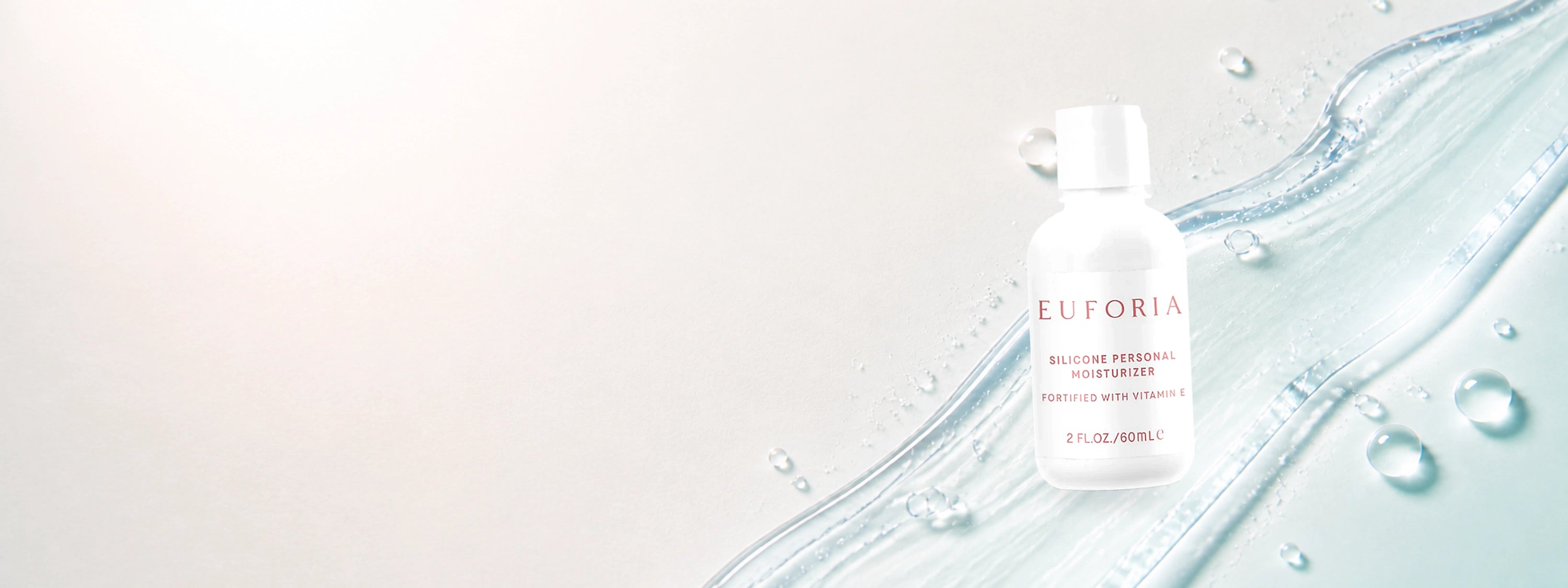 Silicone personal moisturizer displayed on a soft blush editorial set.
