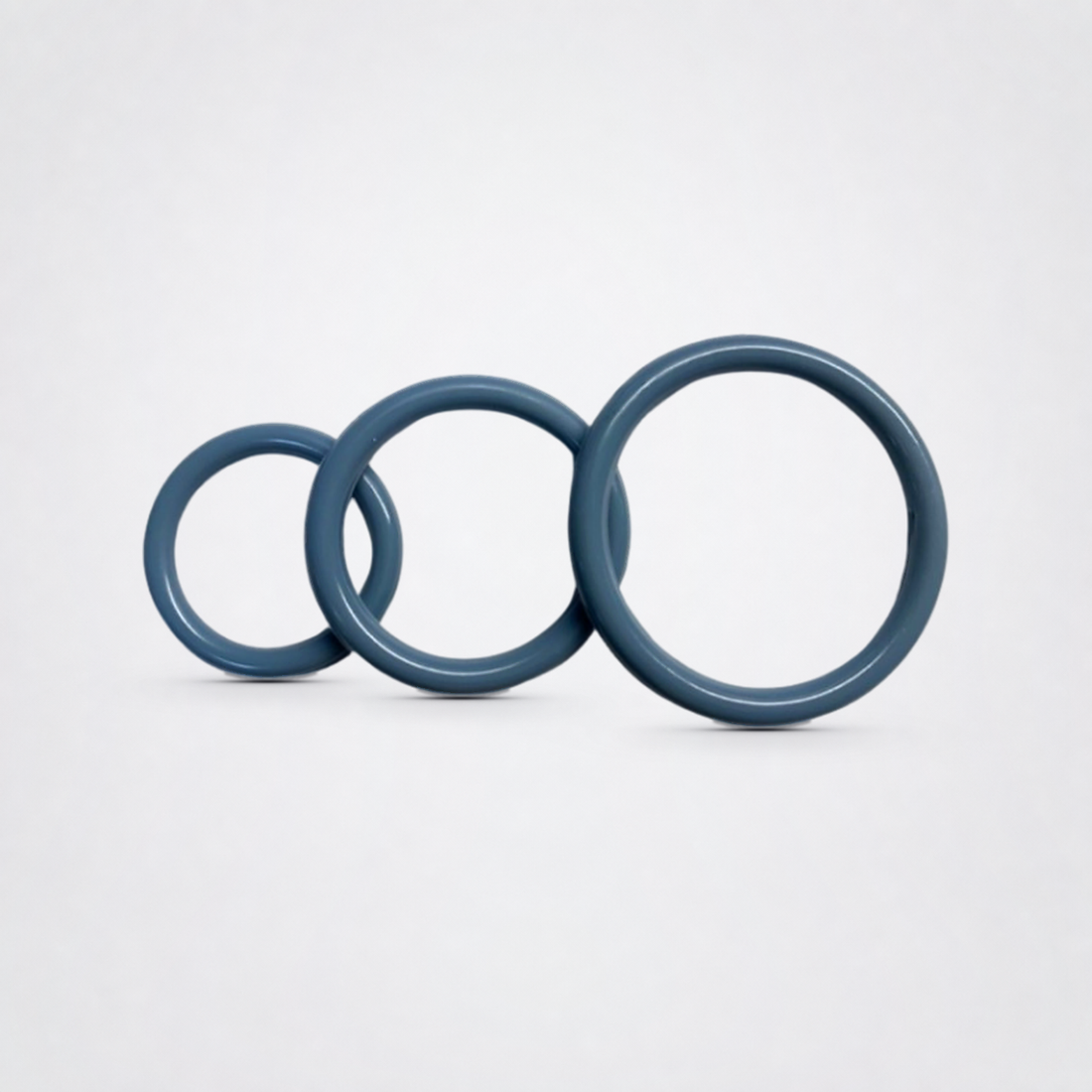 Three-piece silicone ring set in blue on the Luv Coach neutral studio background