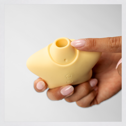 Star Power Airotic Vibrator shown in hand in a square grey-framed photo