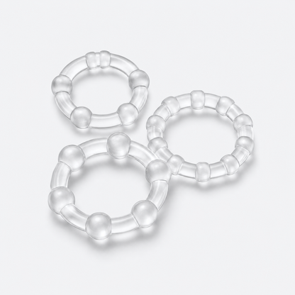 Set of three clear stay-hard rings on a pale grey studio background