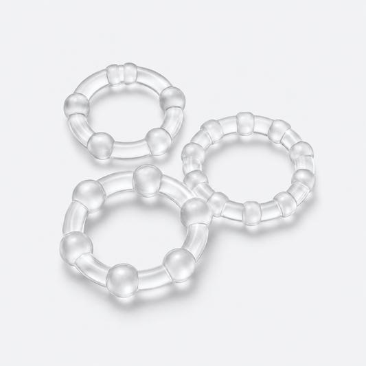 Set of three clear stay-hard rings on a pale grey studio background