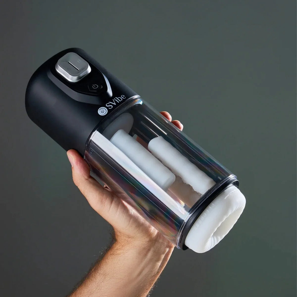 SVibe VOLT held in one hand on its original dark background to show scale and the transparent chamber