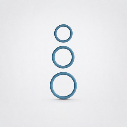 Three blue silicone penis rings in graduated sizes on a neutral grey studio background