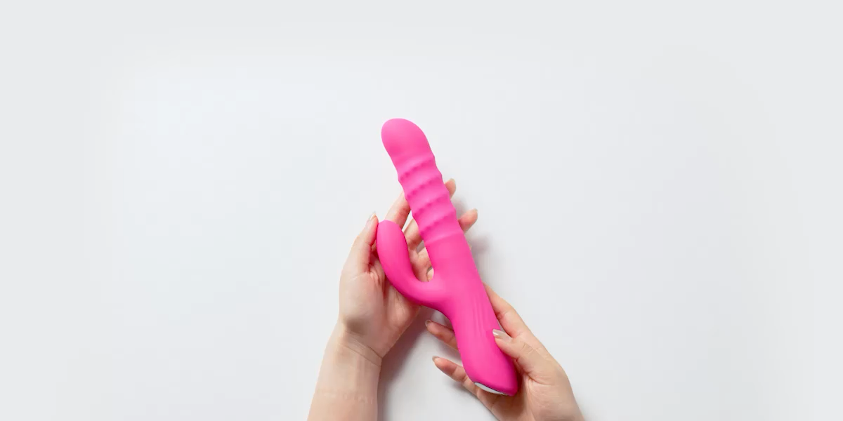 Hands holding the Velvo rabbit vibrator to show its scale